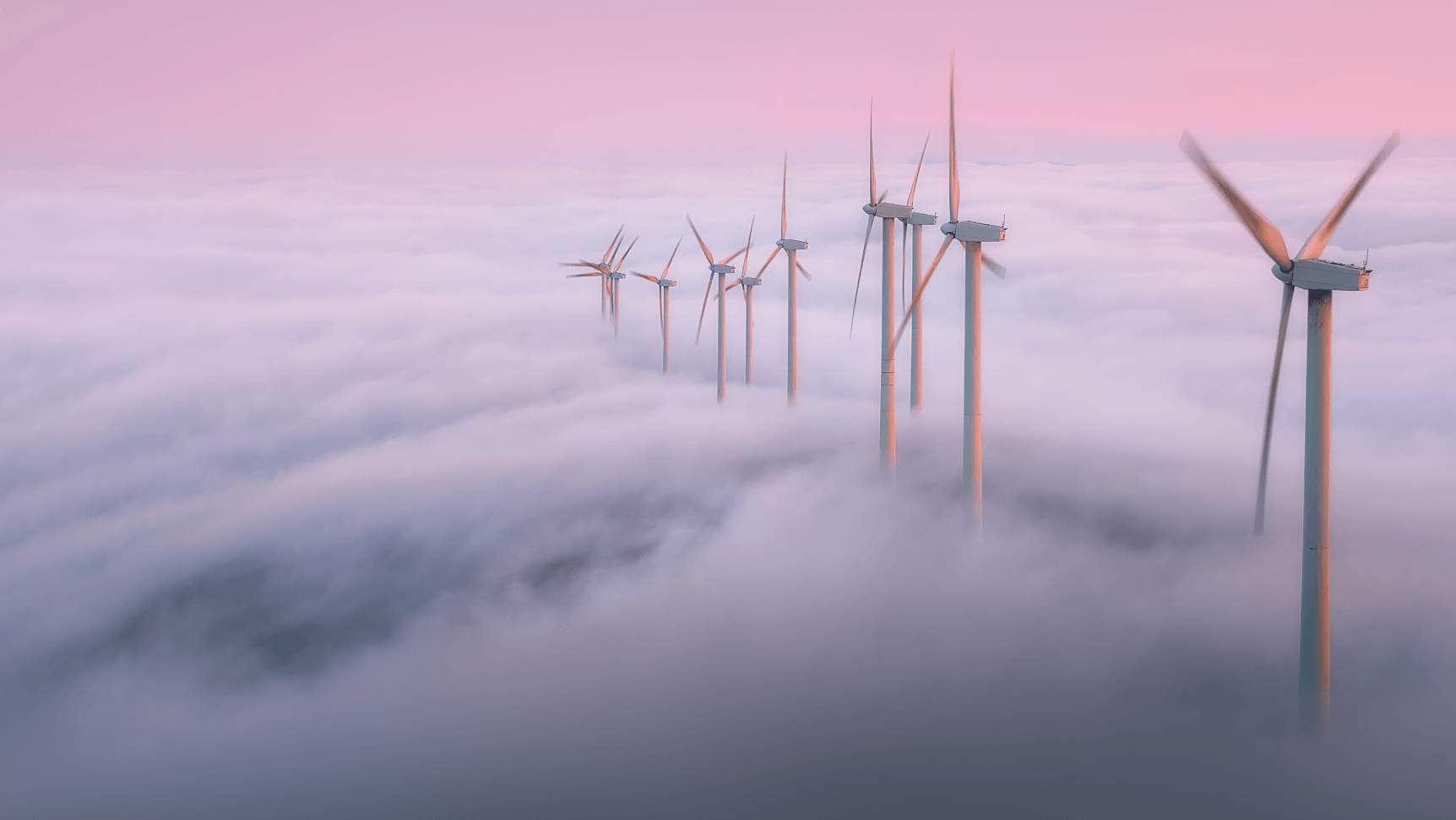 large windmills on foggy field